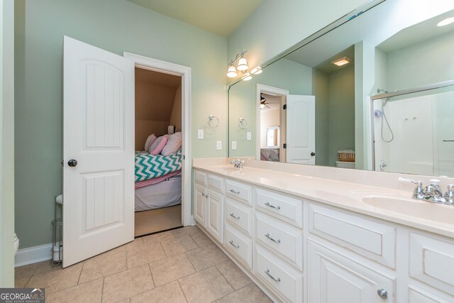 bedroom featuring ornamental molding, a ceiling fan, a tray ceiling, baseboards, and light colored carpet