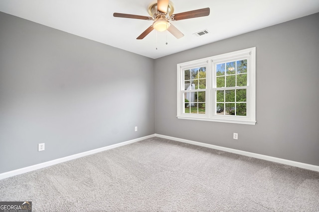 unfurnished room with visible vents, ceiling fan, baseboards, and carpet