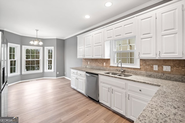 kitchen featuring light wood-style floors, stainless steel dishwasher, white cabinetry, a chandelier, and a sink