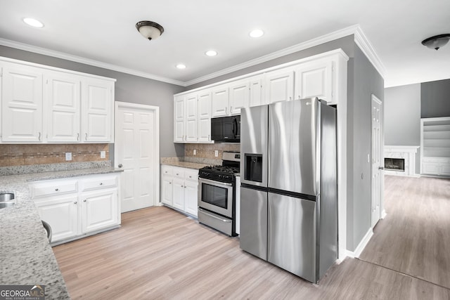 kitchen featuring light wood-style floors, appliances with stainless steel finishes, and white cabinets