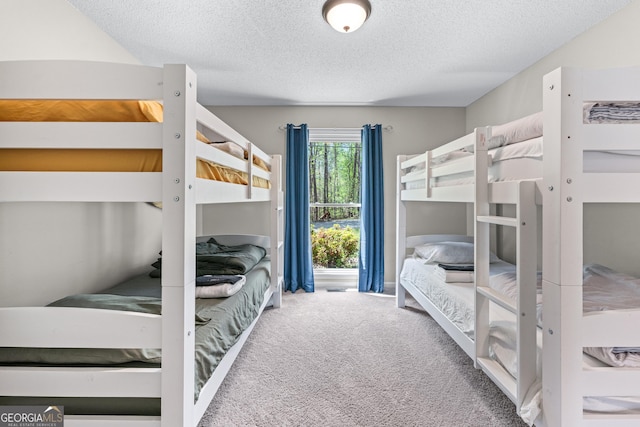 carpeted bedroom with a textured ceiling