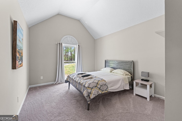 carpeted bedroom featuring lofted ceiling and baseboards