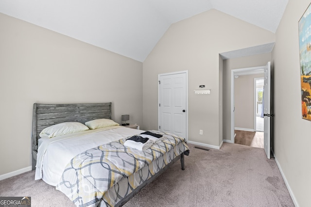 bedroom with vaulted ceiling, visible vents, carpet flooring, and baseboards