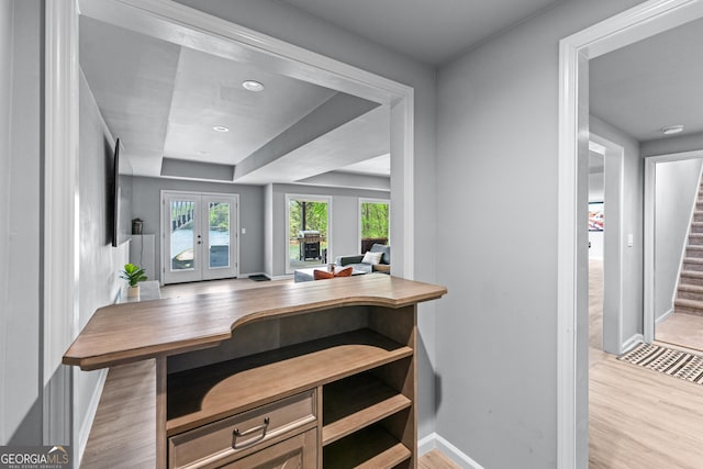 interior space with baseboards, french doors, and wood finished floors