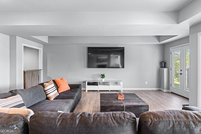 living area with baseboards and wood finished floors