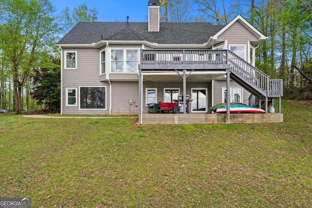 back of house with a chimney, a yard, a patio area, and a deck