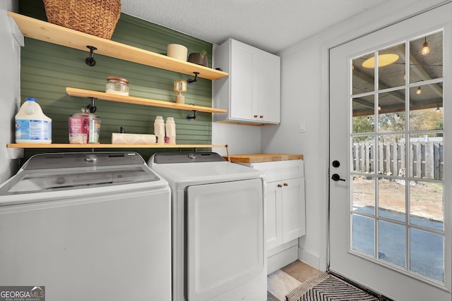 132 4th St, Meldrim, GA 31318 - clothes washing area with washer and clothes dryer, cabinet space, and a textured ceiling