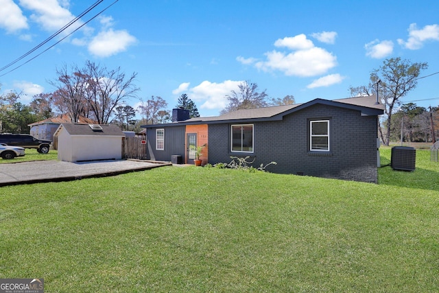 132 4th St, Meldrim, GA 31318 - view of front of home with central AC unit, a chimney, a front lawn, crawl space, and brick siding