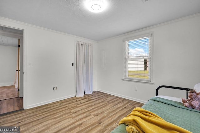132 4th St, Meldrim, GA 31318 - bedroom featuring crown molding, light wood-type flooring, and baseboards