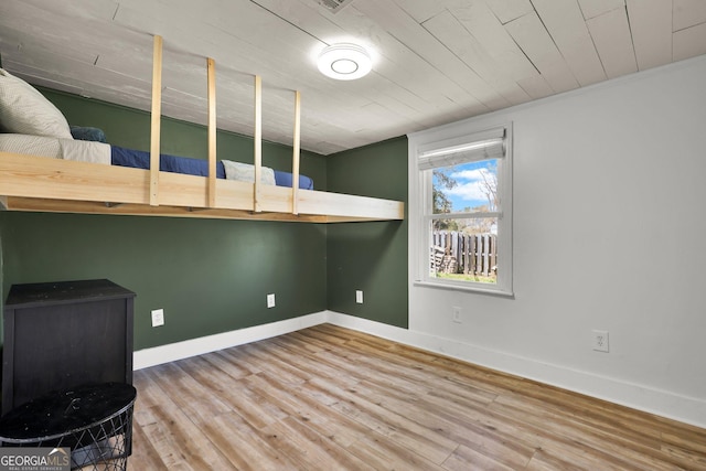 132 4th St, Meldrim, GA 31318 - bedroom with wood ceiling, baseboards, and wood finished floors