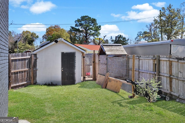 132 4th St, Meldrim, GA 31318 - view of yard featuring a fenced backyard, a storage unit, and an outdoor structure