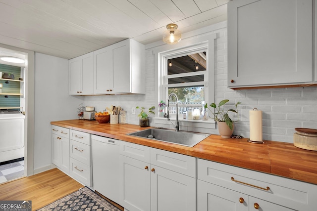 132 4th St, Meldrim, GA 31318 - kitchen with tasteful backsplash, wooden counters, dishwasher, washer / dryer, and a sink
