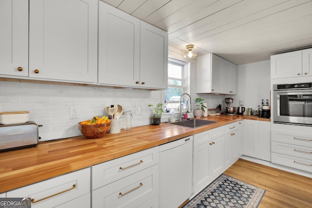 132 4th St, Meldrim, GA 31318 - kitchen with oven, a sink, backsplash, white dishwasher, and wooden counters