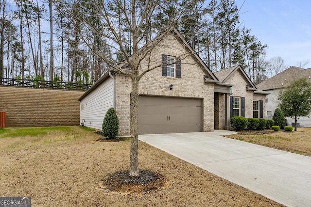 view of front facade featuring brick siding, driveway, and a garage