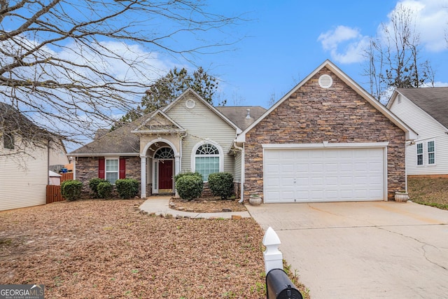 view of front of home featuring a garage, stone siding, and concrete driveway