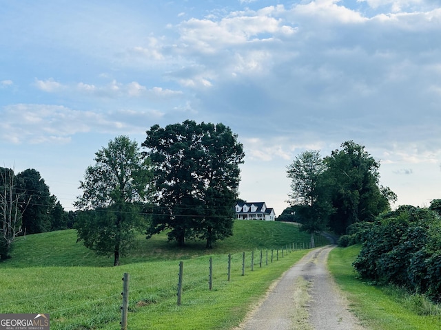 view of street featuring a rural view and driveway