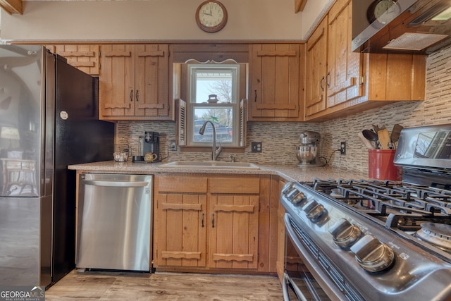 625 Sunnyside Shores Rd, Hiawassee, GA 30546 - kitchen with ventilation hood, light wood finished floors, a sink, stainless steel appliances, and light countertops