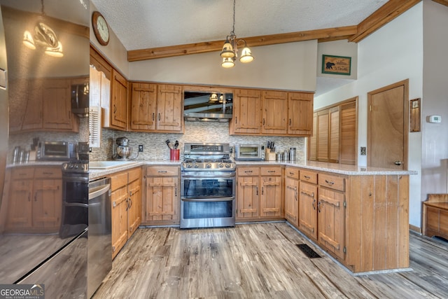 625 Sunnyside Shores Rd, Hiawassee, GA 30546 - kitchen featuring lofted ceiling with beams, decorative backsplash, appliances with stainless steel finishes, a peninsula, and light wood-style floors