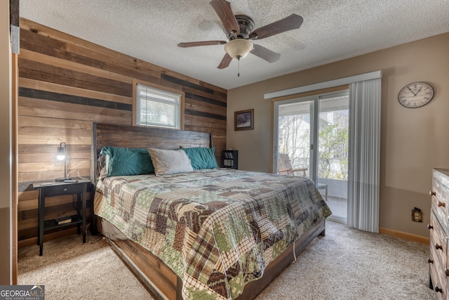 625 Sunnyside Shores Rd, Hiawassee, GA 30546 - carpeted bedroom featuring baseboards, wood walls, a textured ceiling, and a ceiling fan