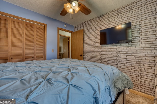 625 Sunnyside Shores Rd, Hiawassee, GA 30546 - unfurnished bedroom featuring ceiling fan, a closet, brick wall, and a textured ceiling