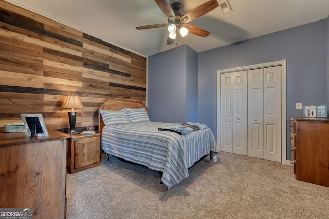 625 Sunnyside Shores Rd, Hiawassee, GA 30546 - carpeted bedroom with a closet, wooden walls, ceiling fan, and visible vents