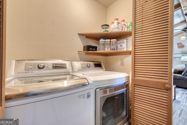 625 Sunnyside Shores Rd, Hiawassee, GA 30546 - laundry room featuring washer and dryer, laundry area, wood finished floors, and a textured ceiling