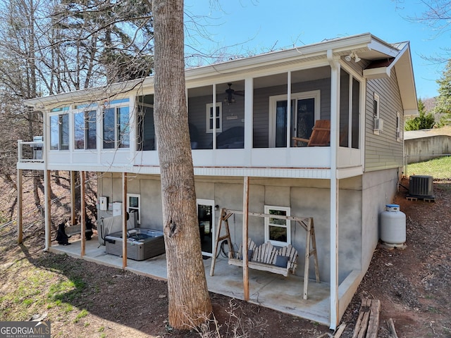 625 Sunnyside Shores Rd, Hiawassee, GA 30546 - back of property with a patio, central air condition unit, a ceiling fan, and a sunroom