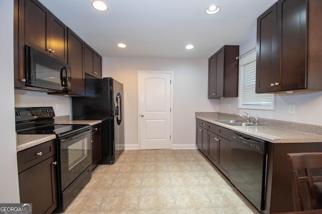 104 Park View Dr, Grantville, GA 30220 - kitchen with light countertops, a sink, black appliances, and dark brown cabinets