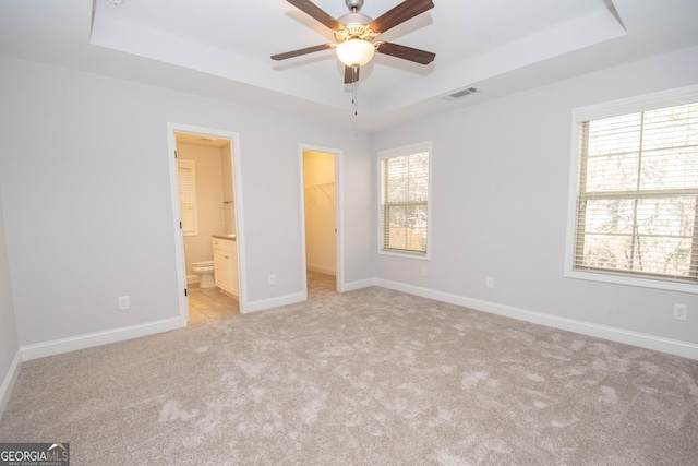 104 Park View Dr, Grantville, GA 30220 - unfurnished bedroom with a spacious closet, visible vents, a tray ceiling, and baseboards
