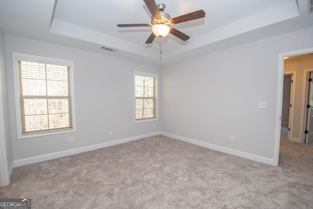 104 Park View Dr, Grantville, GA 30220 - spare room featuring visible vents, baseboards, ceiling fan, carpet floors, and a tray ceiling