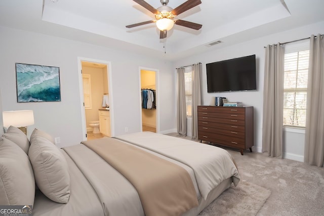 104 Park View Dr, Grantville, GA 30220 - bedroom featuring a walk in closet, visible vents, a raised ceiling, and light colored carpet