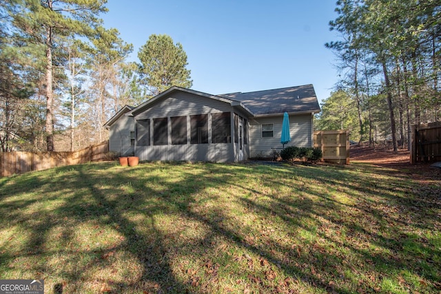 104 Park View Dr, Grantville, GA 30220 - back of property featuring a sunroom, a yard, and fence