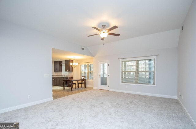 104 Park View Dr, Grantville, GA 30220 - living area with baseboards, light colored carpet, lofted ceiling, and ceiling fan with notable chandelier