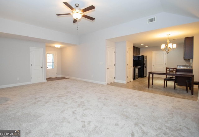104 Park View Dr, Grantville, GA 30220 - living area with visible vents, lofted ceiling, light carpet, and ceiling fan with notable chandelier