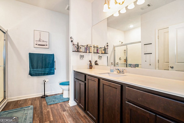 215 Apalachee Dr, Bethlehem, GA 30620 - full bathroom featuring a shower stall, wood finished floors, vanity, baseboards, and toilet
