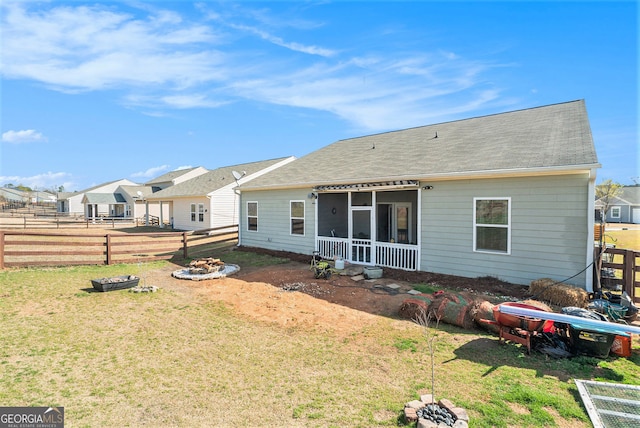 215 Apalachee Dr, Bethlehem, GA 30620 - back of property featuring a residential view, an outdoor fire pit, a sunroom, a fenced backyard, and a yard