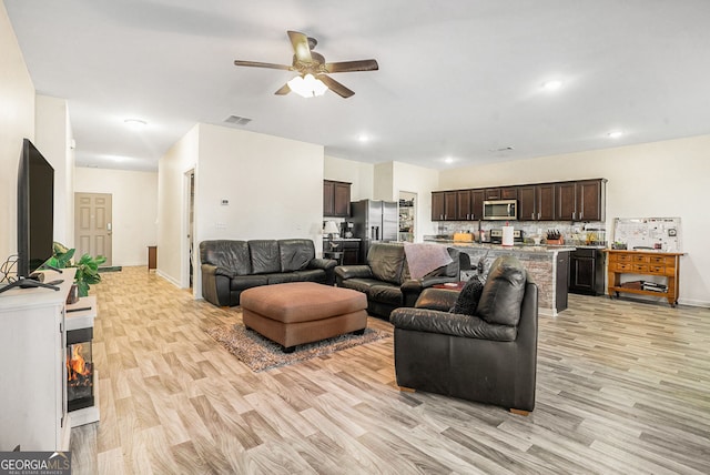 215 Apalachee Dr, Bethlehem, GA 30620 - living room featuring visible vents, baseboards, ceiling fan, and light wood-type flooring