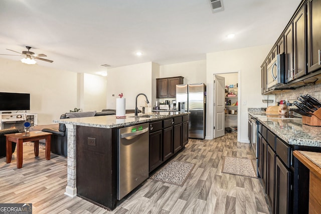 215 Apalachee Dr, Bethlehem, GA 30620 - kitchen featuring visible vents, light wood-style floors, open floor plan, a sink, and stainless steel appliances
