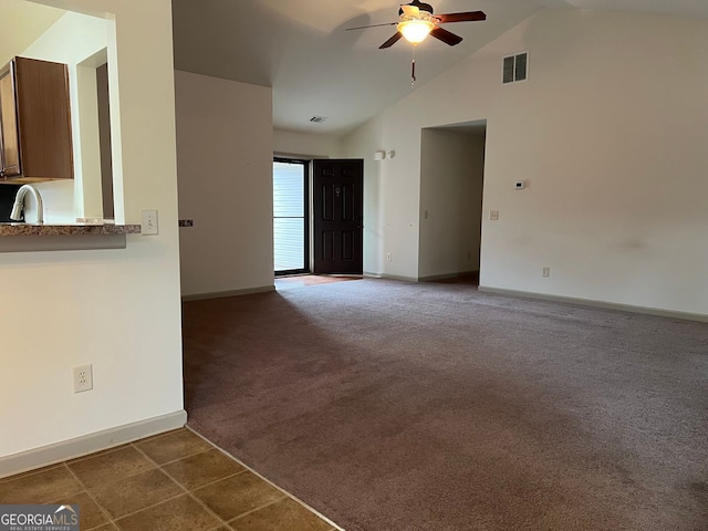 unfurnished living room featuring a ceiling fan, baseboards, visible vents, and dark colored carpet