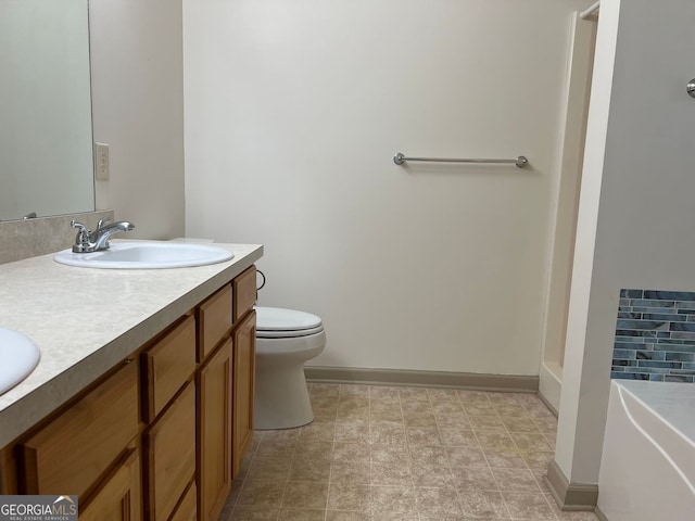 full bath featuring double vanity, toilet, baseboards, and a sink