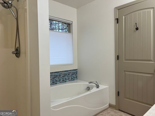 bathroom featuring tile patterned flooring, a bath, and a shower