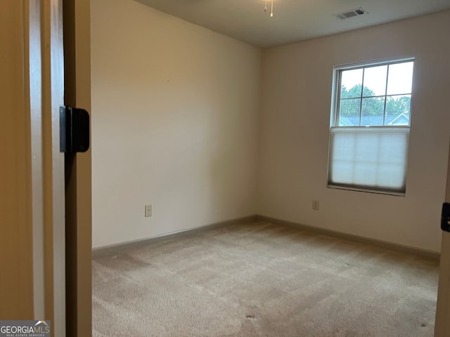 carpeted empty room with baseboards and visible vents