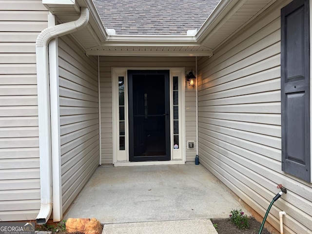 property entrance with roof with shingles