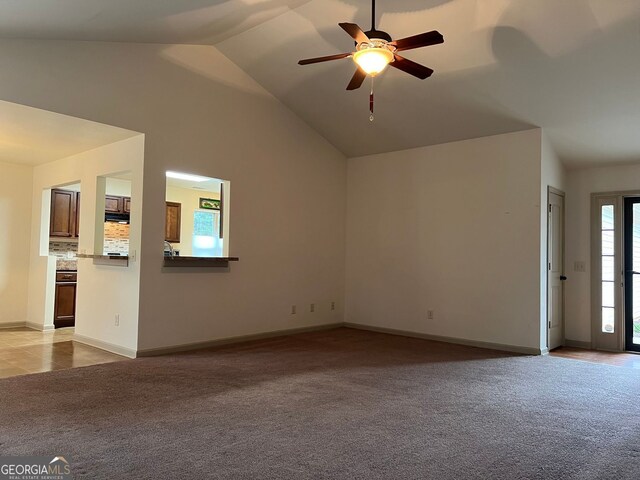 unfurnished living room featuring a ceiling fan, baseboards, light colored carpet, and lofted ceiling