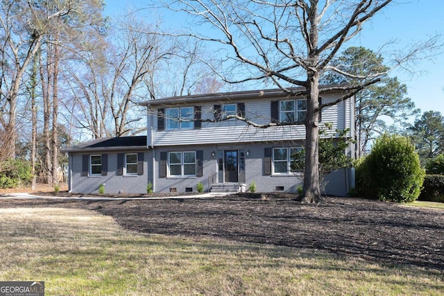 colonial home featuring a front yard