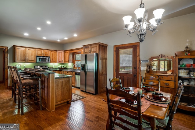 2778 Kelly Ln, Hiawassee, GA 30546 - kitchen with stainless steel appliances, a chandelier, recessed lighting, wood finished floors, and a kitchen breakfast bar