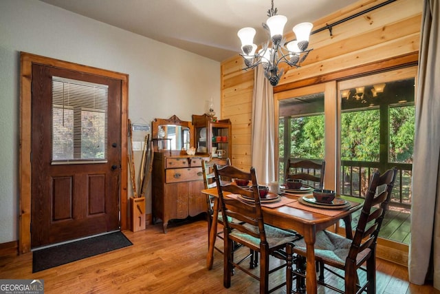 2778 Kelly Ln, Hiawassee, GA 30546 - dining area featuring light wood-style floors, a chandelier, and wooden walls