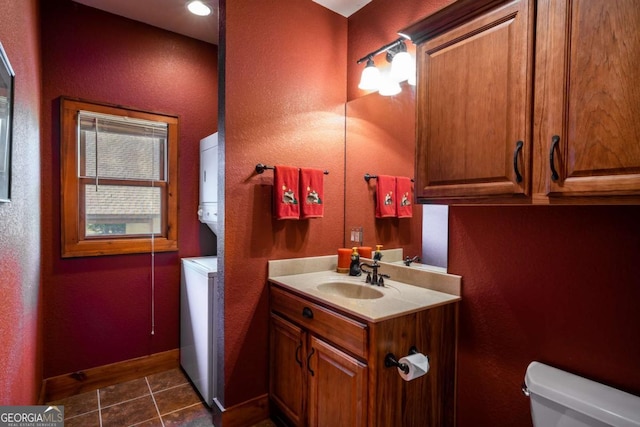 2778 Kelly Ln, Hiawassee, GA 30546 - half bath with stacked washing machine and dryer, vanity, tile patterned floors, and a textured wall