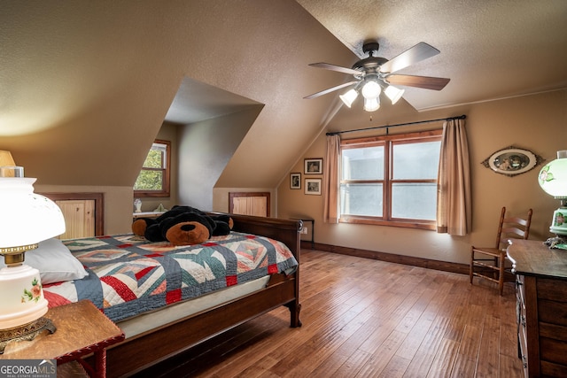 2778 Kelly Ln, Hiawassee, GA 30546 - bedroom with lofted ceiling, wood-type flooring, a textured ceiling, and ceiling fan