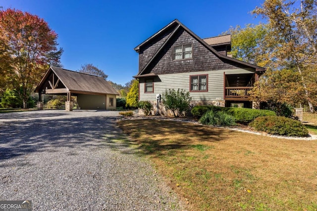 2778 Kelly Ln, Hiawassee, GA 30546 - view of home's exterior featuring gravel driveway, a carport, an outbuilding, and a lawn